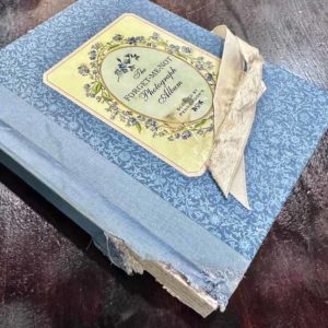 a photo album that had binding chewed badly by rats