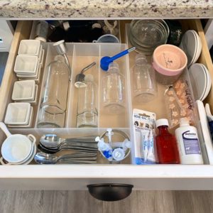 a drawer with an organizer stocked with supplies