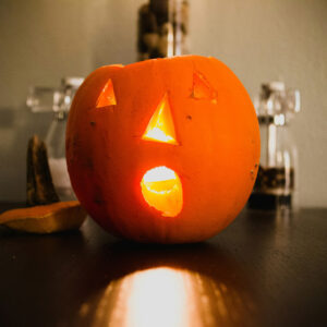 carved pumpkin lit up on table