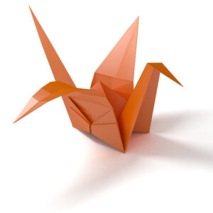 folded paper origami bird crane with orange paper
