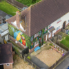aerial view of mural featuring parrots on a home in England
