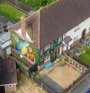 aerial view of mural featuring parrots on a home in England