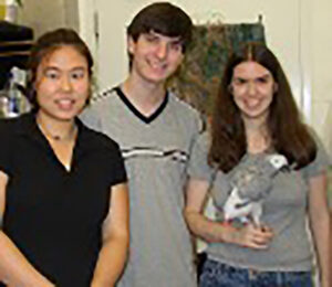 Students at Brandeis pose with African grey parrot