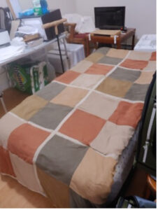 bed spread on top of bird cages