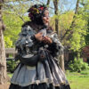 women dressed as pigeon in park talks to children