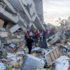 rescue workers on earthquake debris