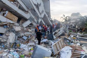 rescue workers on earthquake debris